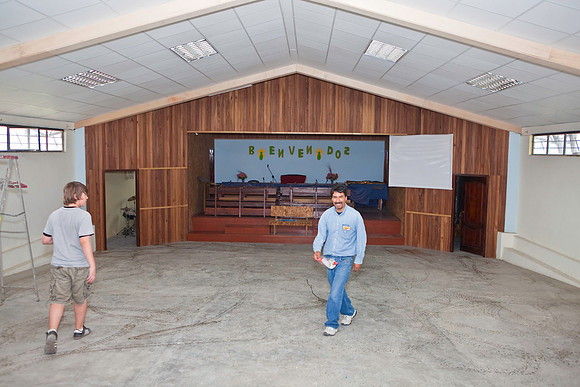 Pastor Hernan wetting down the floors because of all the dust