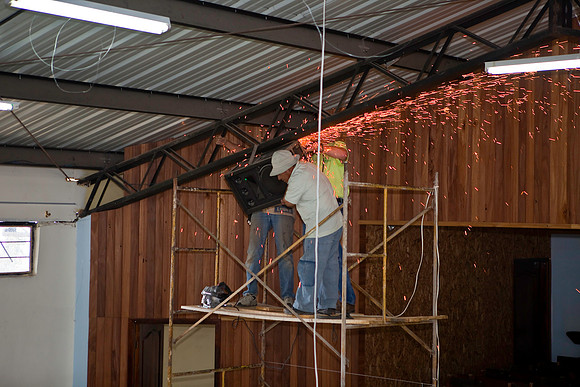 The speakers were welded to the trusses.  They had to come down